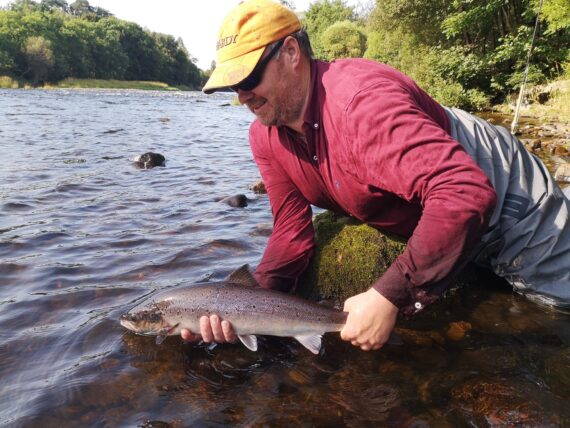 Charles Hewitt releasing one of his four fish caught at Easter Elchies